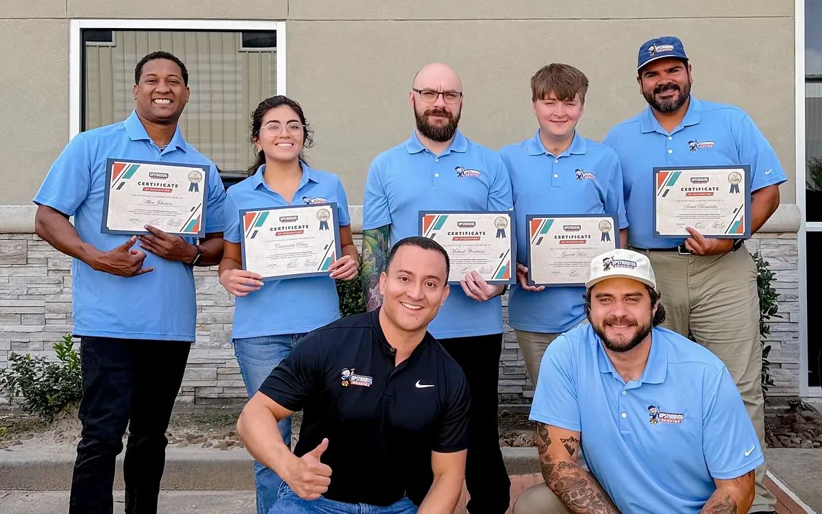 Ben Pacheco with members of the Upstanding Roofing team holding completed training certificates
